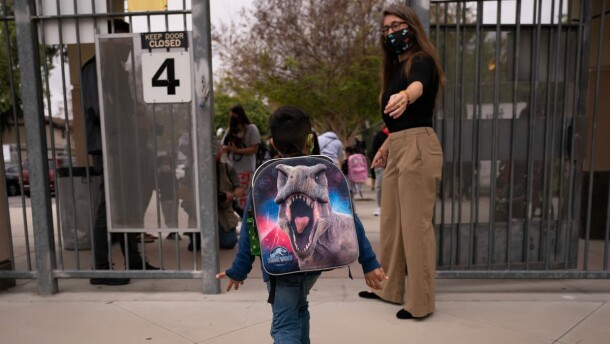 Kindergartener Angel Hernandez leaves after the first day of in-person learning at Maurice Sendak Elementary School in Los Angeles, Tuesday, April 13, 2021.