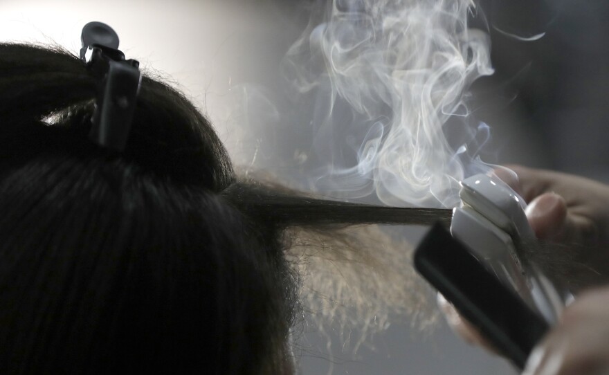 Steam rises as a hair stylist works on a model prior to a show displaying the Tom Ford collection during Fashion Week on Feb. 6, 2019, in New York. People of color in the industry trace bias and discrimination in predominantly white salons to the sidelining of formal education focused on Black hair.