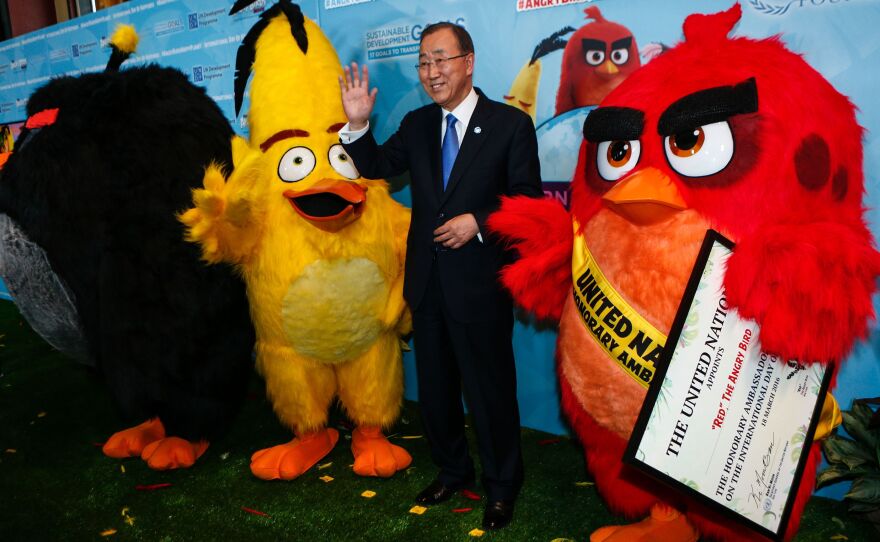 U.N. Secretary-General Ban Ki-moon poses after naming "Red the Angry Bird" as an honorary ambassador to the United Nations on March 18.
