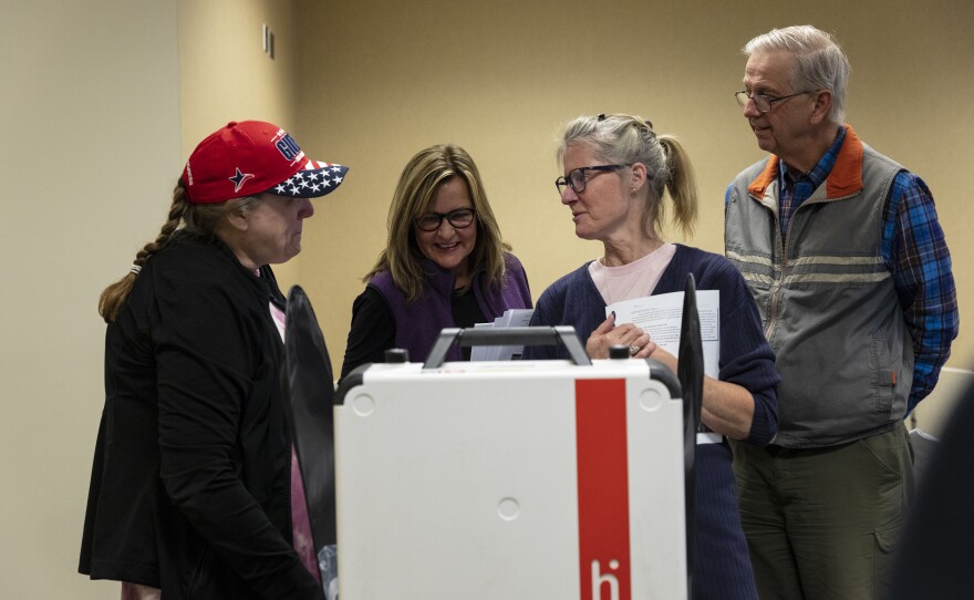 Poll workers at the Ottawa County Clerk building in West Olive, Michigan get training in assembling a machine that helps people vote.