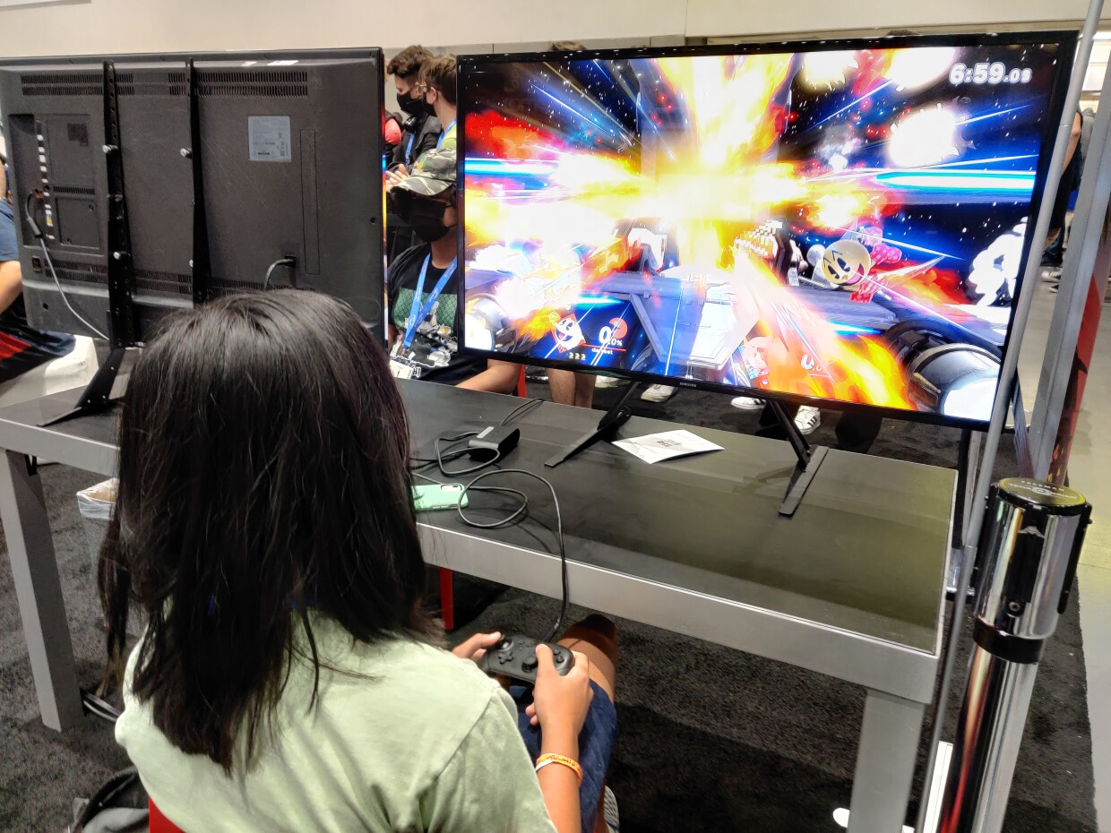 Gamers Darrest and Mark go head-to-head on Super Smash Bros. inside Comic-Con's Exhibit Hall, July 24, 2022.