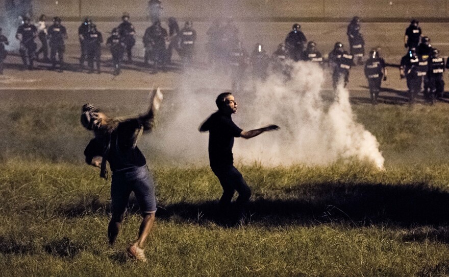 Protesters throw objects at police officers on I-85 in Charlotte, N.C., in the early hours of Wednesday morning.