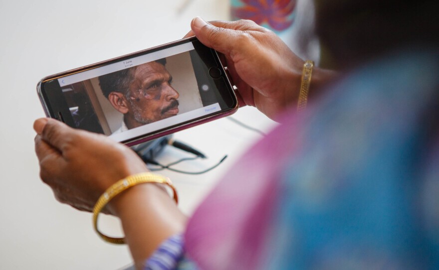 Syeda Fatima, a human rights activist from Pakistan, shows a photo of a laborer she helped rescue. He asked that his name not be given to protect his identity.