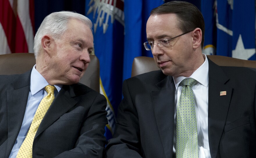 Attorney General Jeff Sessions speaks with Deputy Attorney General Rod Rosenstein at an event at the Department of Justice in Washington, D.C. on Feb. 2, 2018.