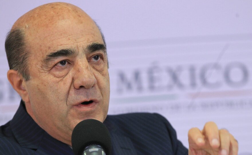 Mexico's Attorney General Jesus Murillo Karam addresses a news conference in Mexico City on Friday. He announced the arrest of three suspects in the brutal slaying of 43 students in the country's south.