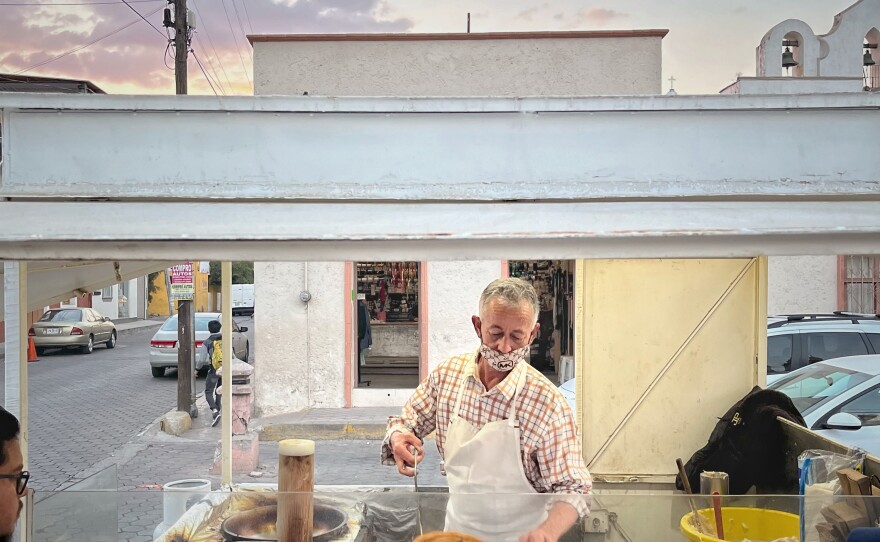 Martin Elizalde Valenzuela paints houses in the morning and is happy to sell his churros in the afternoon. The photo was taken in Jalisco, Mexico, on Dec. 26, 2022.