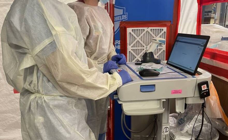 Dr. Parimal Bharucha and colleague reviewing patient records inside the ICU COVID-19 unit at Dignity Health Mercy Hospital. 'It's like post-traumatic stress disorder that we all go through,' said Bharucha about the current surge. 'It is a communal sense of grief.'
