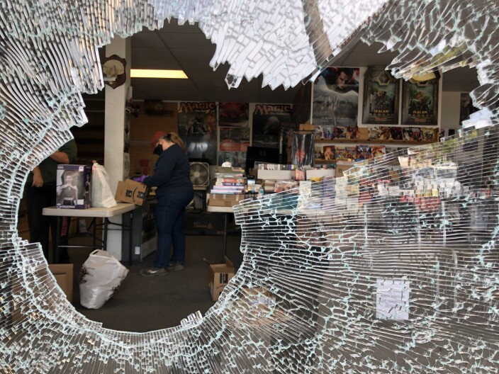 A hole in the window of a comic book store in La Mesa following a night of protests, May 31, 2020. 