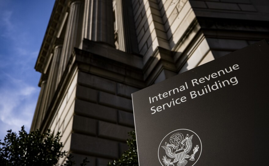 Signage outside the IRS headquarters in Washington, D.C., is shown on March 19. The IRS' plan on bank accounts would require lenders to report the annual total of deposits and withdrawals, not individual transactions.