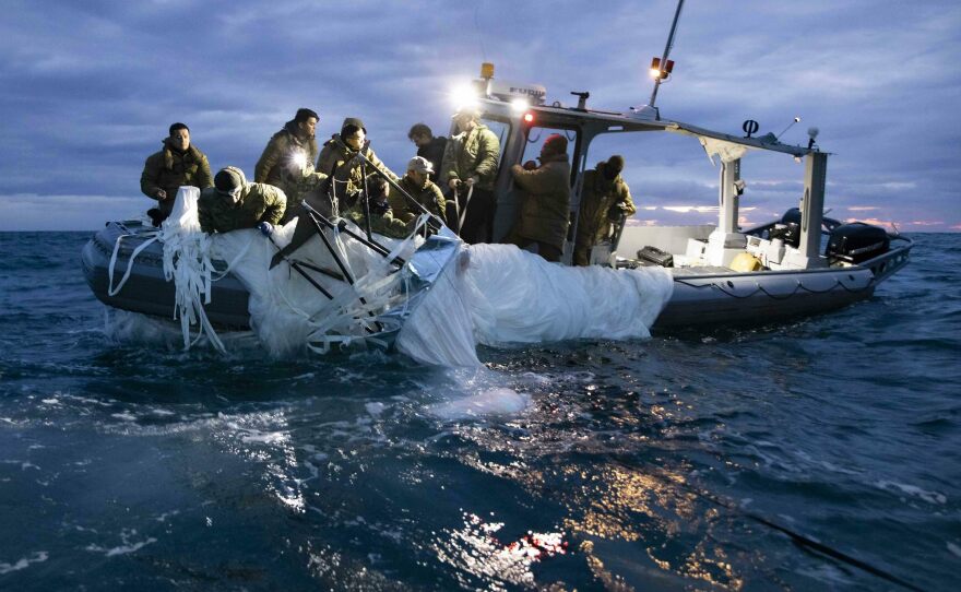 Sailors recover a high-altitude surveillance balloon in the waters off the coast of Myrtle Beach, S.C., on Feb. 5, after a fighter jet shot the balloon out of the sky.