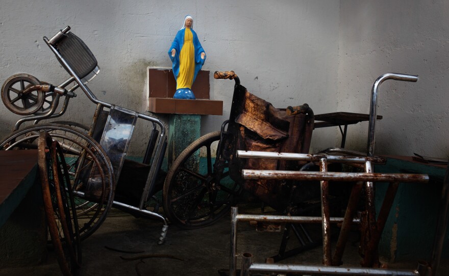 Photographer Wil Riera says the freshly painted icon of the Virgin Mary represents "hope in the middle of chaos."