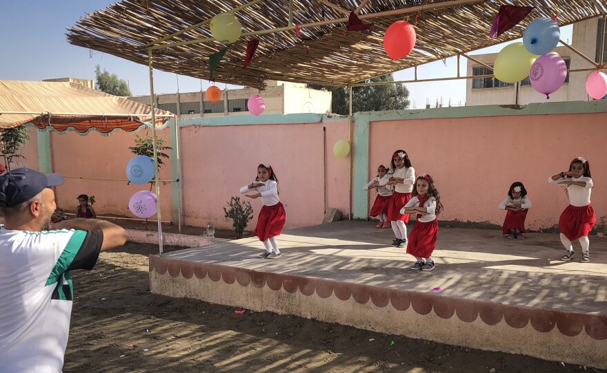 Schoolchildren are led through a dance routine at a U.S. government-supported childcare center in Raqqa.