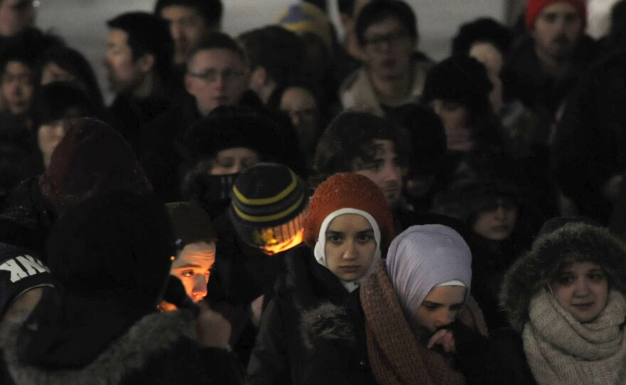 Several vigils were held last night in honor of three young Muslims who were killed in Chapel Hill, N.C., Tuesday. Here, attendees are seen at an event on the campus of the University of Michigan.