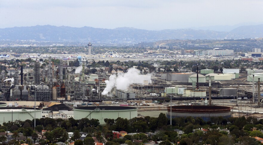 This file aerial photo shows the Standard Oil Refinery in El Segundo, Calif., with Los Angeles International Airport in the background and the El Porto neighborhood of Manhattan Beach, Calif., in the foreground, May 25, 2017.