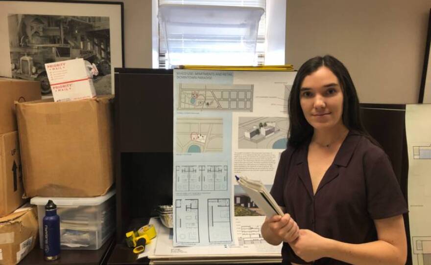 Cal Poly student Elisabeth Frizzel stands in front of her plans for a downtown Paradise that includes mixed-use housing and retail buildings in this undated photo.