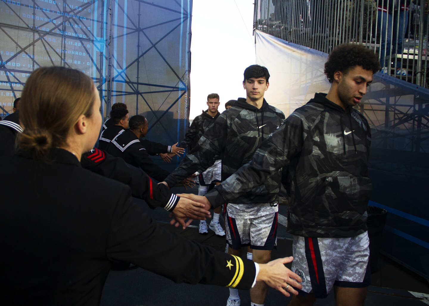 Members of the Gonzaga team greet Navy sailors as they return to the court after halftime during the Armed Forces Classic on board the USS Abraham Lincoln in San Diego on Nov. 11, 2022.