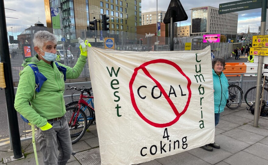 Activists hold a banner against West Cumbria's planned coking coal mine as they stand near the Scottish Event Campus, the venue for the U.N. climate summit, in Glasgow.