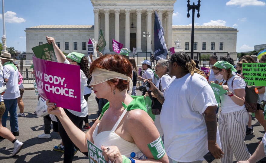 Mahayana Landowne, of Brooklyn, N.Y., wears a "Lady Justice" costume as she marches past the Supreme Court during a protest for abortion rights on June 30, 2022, in Washington, D.C.