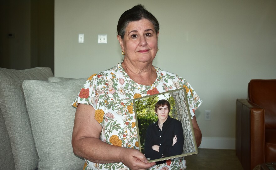Sue Phillips holds a photograph of her son, Matthew. He died after two members of a white supremacist gang beat him until he was unconscious in a recreation cage at Thomson.