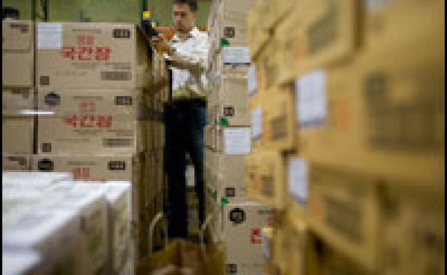 Nick Schaub, consumer safety officer for the FDA, looks for possible contamination signs in a bottle of soy sauce.