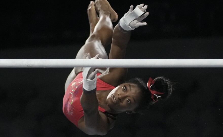Biles practices on the uneven bars on Friday.