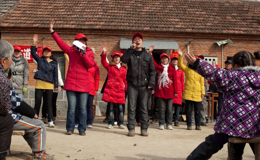 A group of young Christians preaches on the streets in a rural Chinese village. China's constitution protects freedom of religion but prohibits proselytizing in public places.
