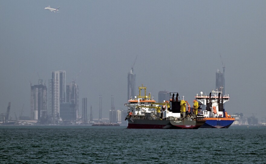 Commercial vessels offshore in Dubai on March 11, 2026. Attacks hit three commercial ships in the Gulf on March 11 as Iran pressed its campaign against its oil-exporting neighbors, threatening shipping in the Strait of Hormuz.