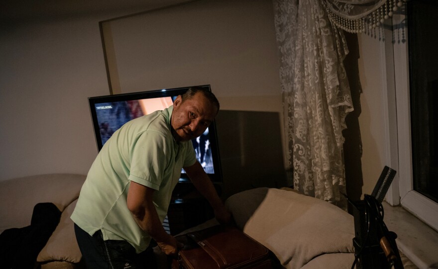 Abdüllatif Kuçar, 54, looks through an old suitcase for photos and documents at his home in Istanbul. After moving to Turkey in 1986, he regularly shuttled between Istanbul and Xinjiang's capital of Urumqi.
