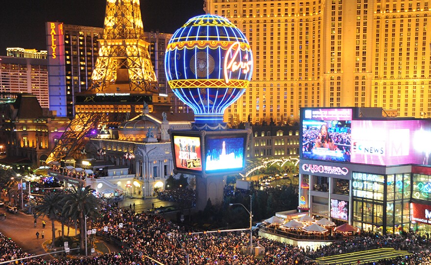 In this photo provided by the Las Vegas News Bureau, visitors crowd the Las Vegas Strip at midnight on Jan 1.