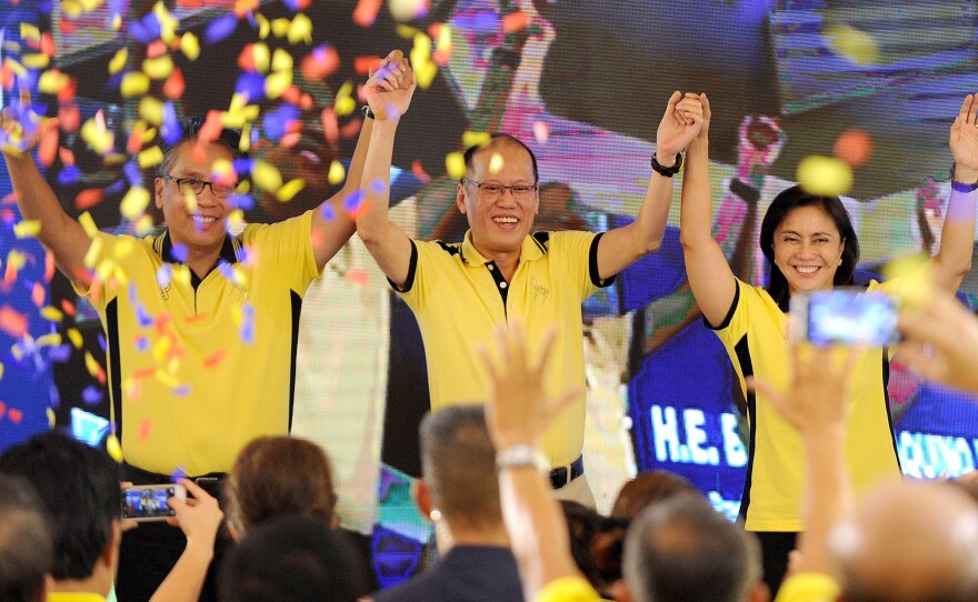 President Benigno Aquino, center, appears with his party's next presidential and vice presidential candidates, Manuel Roxas, left, and Leni Robredo. Aquino is the son of former President Corazon Aquino.