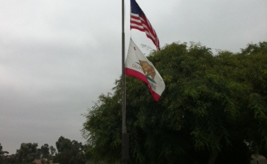 Flags fly at half staff in Colina Del Sol park in City Heights on August 11, 2011. The flags were lowered following the death of San Diego police officer Jeremy Henwood.