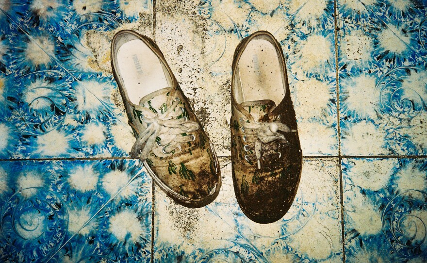 Poole's shoes, caked in mud, after crossing the Honduras border at night.