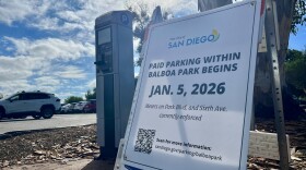 A sign notifying drivers that paid parking begins Jan. 5 is shown inside Balboa Park, San Diego on Jan. 3, 2025. 
