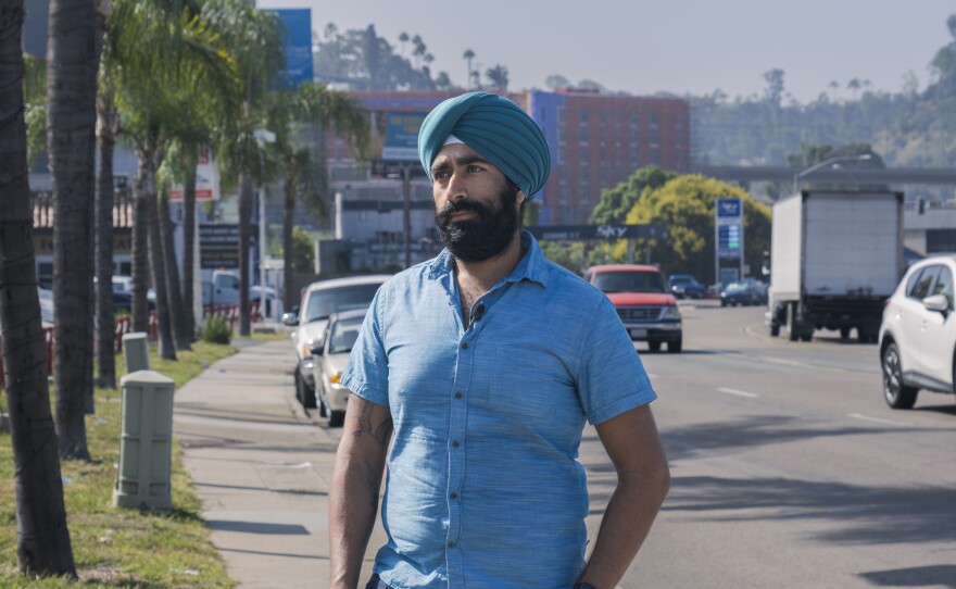 Jiwan Kohli stands in front of the car dealerships and gas stations that characterize his neighborhood of Grantville, Sept. 26, 2023.