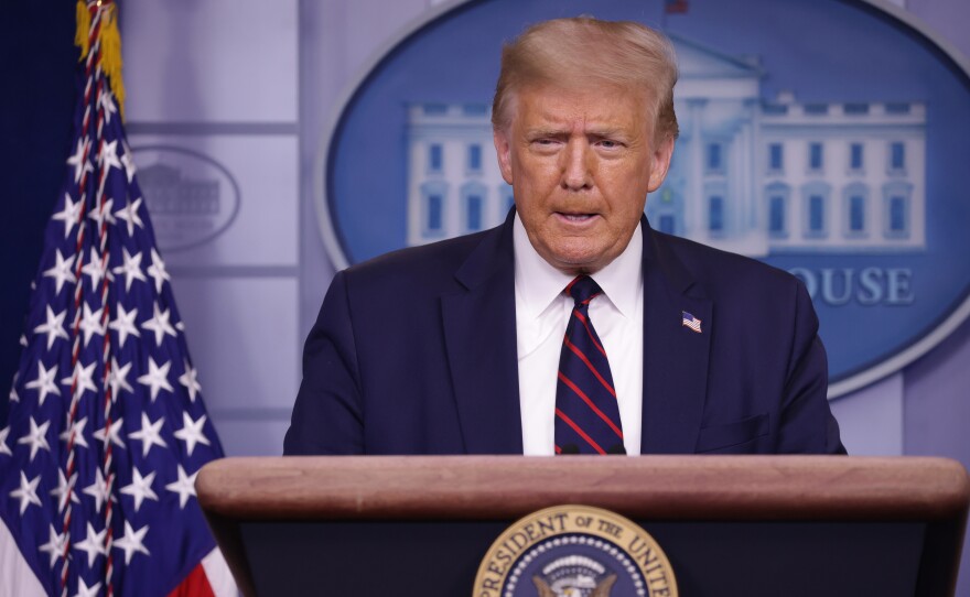 President Trump speaks during a news conference at the White House on July 30. On Saturday, Twitter and Facebook both flagged posts from the president that encouraged Americans to vote by mail and then go to the polls on Election Day to check that their vote was counted.