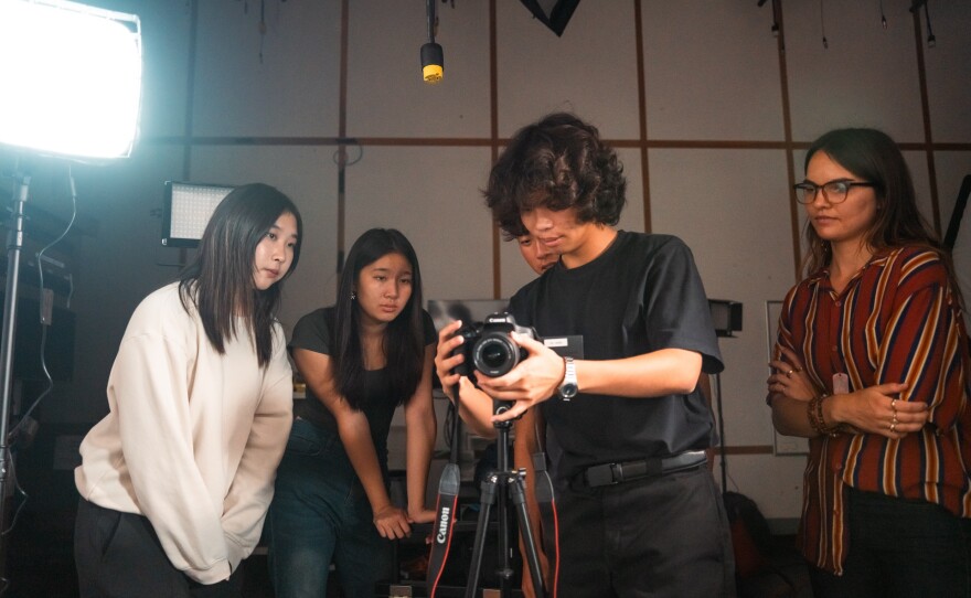 Students set up equipment for a shoot in this undated photo.