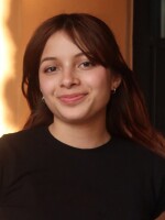 Woman with dark hair smiling at camera