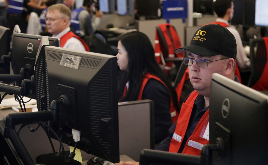 Pacific Gas & Electric employees work in the PG&E Emergency Operations Center in San Francisco. Authorities say power outages have started again in parts of Northern California.