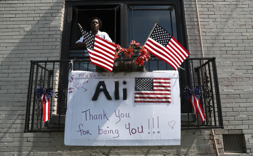 Billy Hazelwood waits in his apartment along the funeral procession route for Muhammad Ali in Louisville, Ky. The procession preceded a memorial service, giving the public an opportunity to honor the world heavyweight boxing champion.