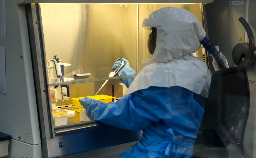 Sophia Mulei, a laboratory technologist, works with a control sample inside the Viral Hemorrhagic Fever Laboratory at Uganda Virus Research Institute in Entebbe, Uganda. The lab is one of the primary centers for the testing of Ebola samples.