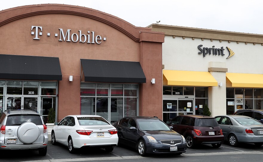 T-Mobile and Sprint stores in El Cerrito, Calif. The Department of Justice approved the $26 billion merger of the two wireless carriers.