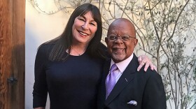 Host Henry Louis Gates, Jr. with actress Anjelica Huston while taping FINDING YOUR ROOTS.