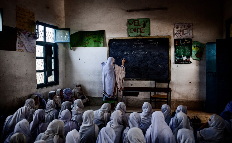 Female students attend class at their school in Pakistan, which was attacked by the Taliban on December 21, 2012 as part of a campaign to prevent girls from accessing education. This photo was taken the following year and was honored in the "long-term project" category, Khyber Pakhtunkhwa, Pakistan. June 4, 2013.