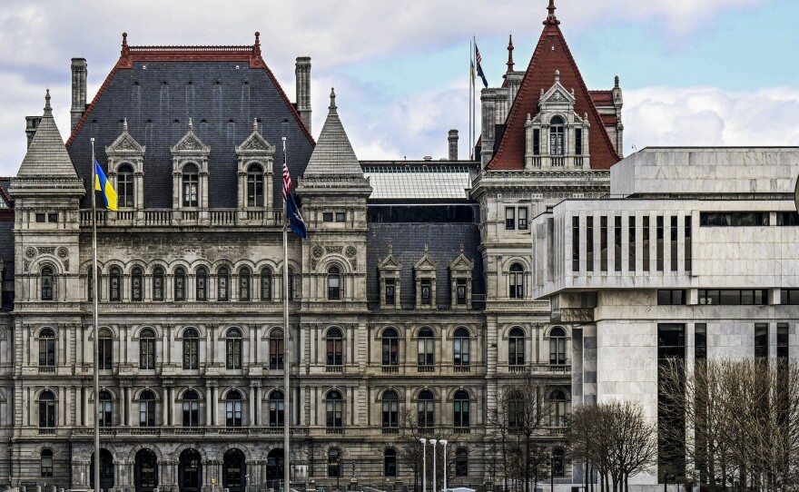 The New York state Capitol building (left) is shown next to the state appellate court building in foreground (right) on April 4 in Albany, N.Y.