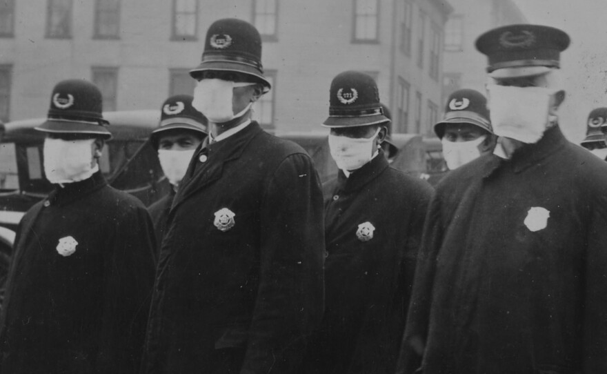 Policemen in Seattle wearing masks made by the Red Cross.1918.