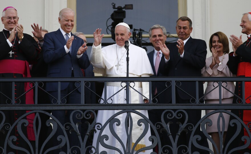 Pope Francis waves to a crowd from the Speaker's Balcony on the West Front of the Capitol Thursday. In his speech, Francis lauded two Catholics: Dorothy Day and Thomas Merton.