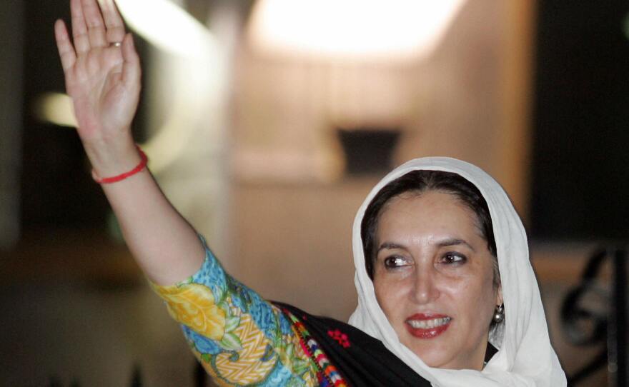 Benazir Bhutto, who served two terms as Pakistan's prime minister, waves to supporters at the Islamabad International airport on Nov. 6, 2007. She was killed in a bombing attack the following month.