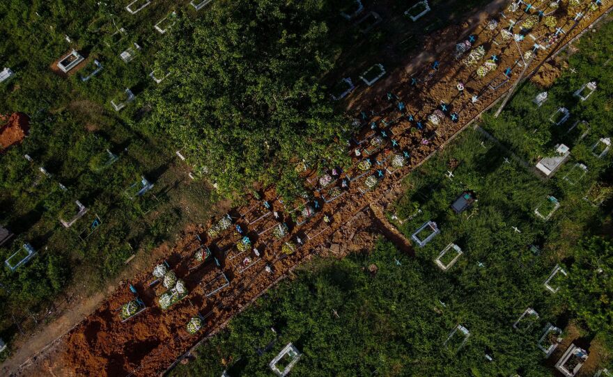 With little space left at Nossa Senhora Aparecida cemetery in Manaus, Brazil, graves of COVID-19 victims line a street, seen in an aerial photo taken on Thursday as the country passed 400,000 virus deaths.