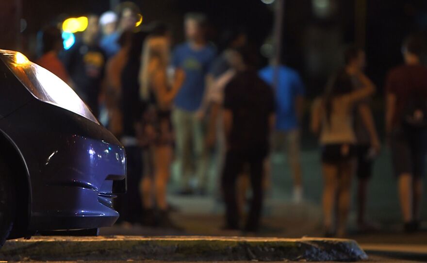 People at Montezuma Road and College Avenue intersection wait for the street lights to change, Aug. 22, 2014.