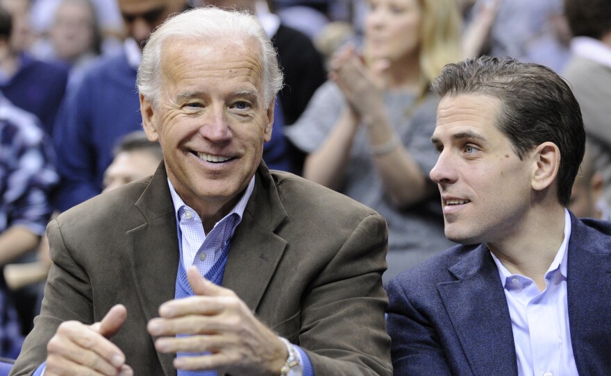 Then-Vice President Joe Biden and his son Hunter Biden attend a basketball game in Washington in 2010. Joe Biden frequently dealt with the Ukrainian government and pressed the government to deal with corruption issues. At the same time, Hunter Biden was on the board of a leading gas company in Ukraine. President Trump and some of his supporters have called for an investigation.
